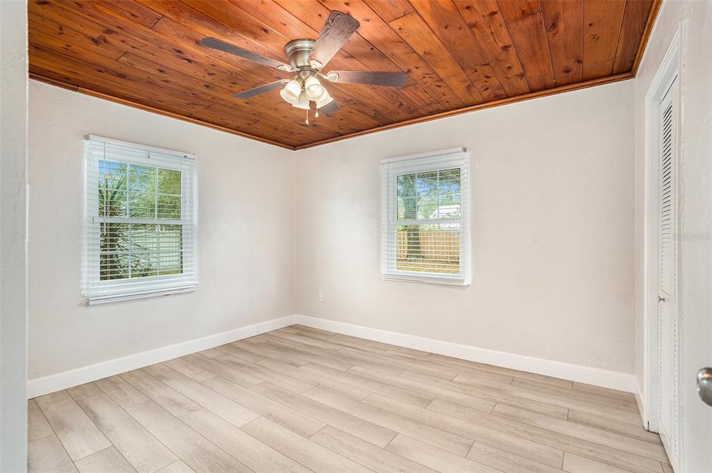 5305 Whiteway Drive Temple Terrace, FL 33617 - Photo 17 of 22 an empty room with wooden floor and windows