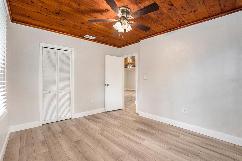 5305 Whiteway Drive Temple Terrace, FL 33617 - Photo 19 of 22 a view of empty room with wooden floor