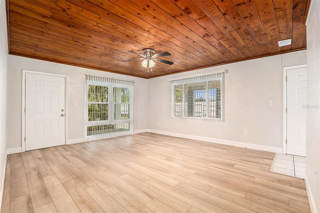 5305 Whiteway Drive Temple Terrace, FL 33617 - Photo 6 of 22 a view of an empty room with wooden floor and a window