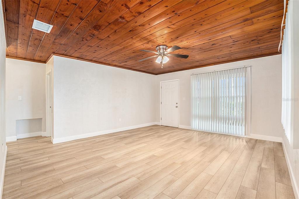 5305 Whiteway Drive Temple Terrace, FL 33617 - Photo 9 of 22 a view of empty room with wooden floor
