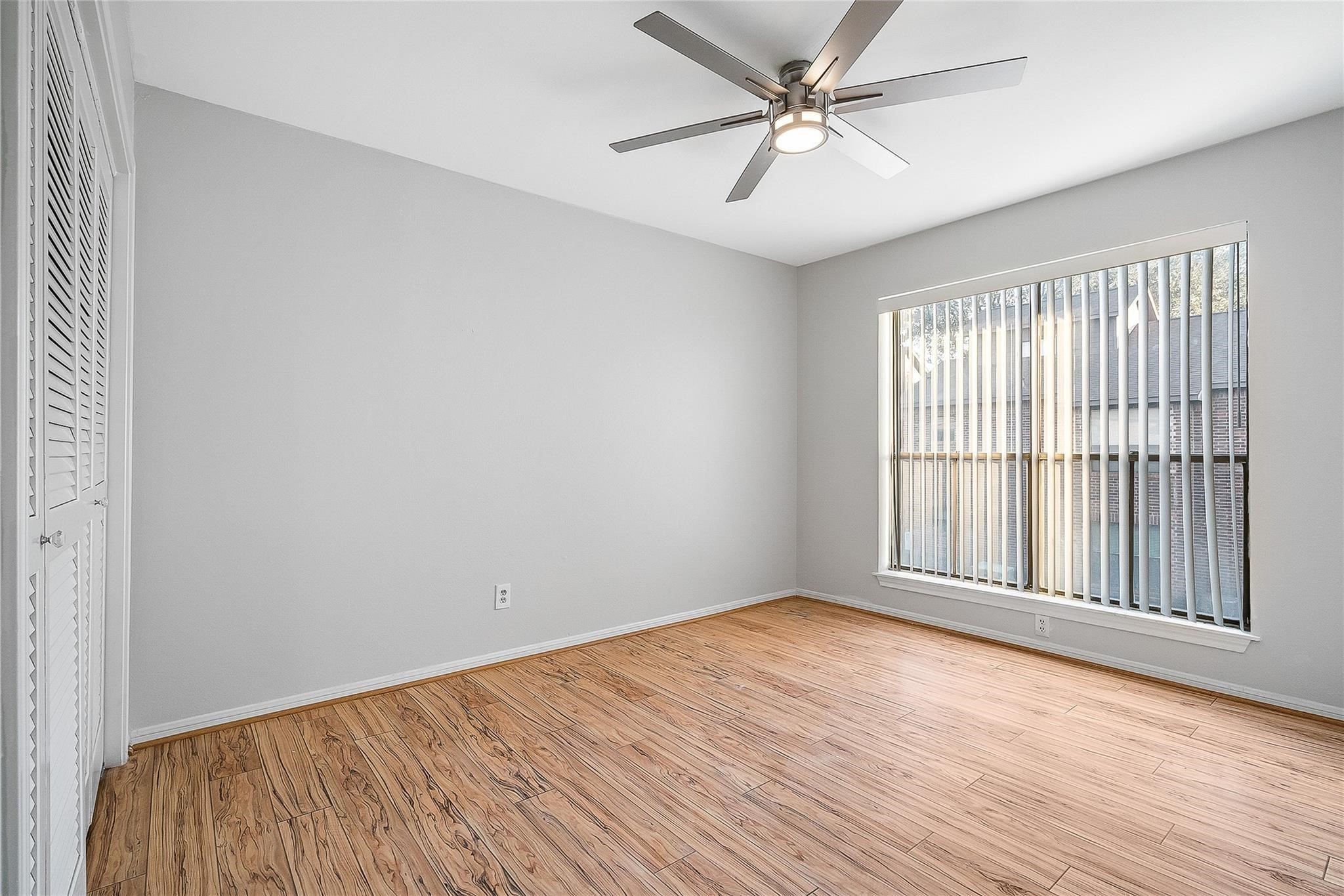 3100 Walnut Bend Lane, Unit 116 Houston, TX 77042 - Photo 13 of 15 wooden floor in an empty room with a window