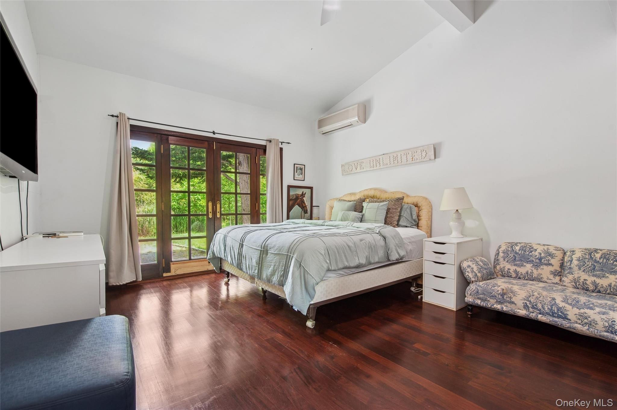 251 Sebonac Road Southampton, NY 11968 - Photo 7 of 15 a bedroom with a bed and a couch
