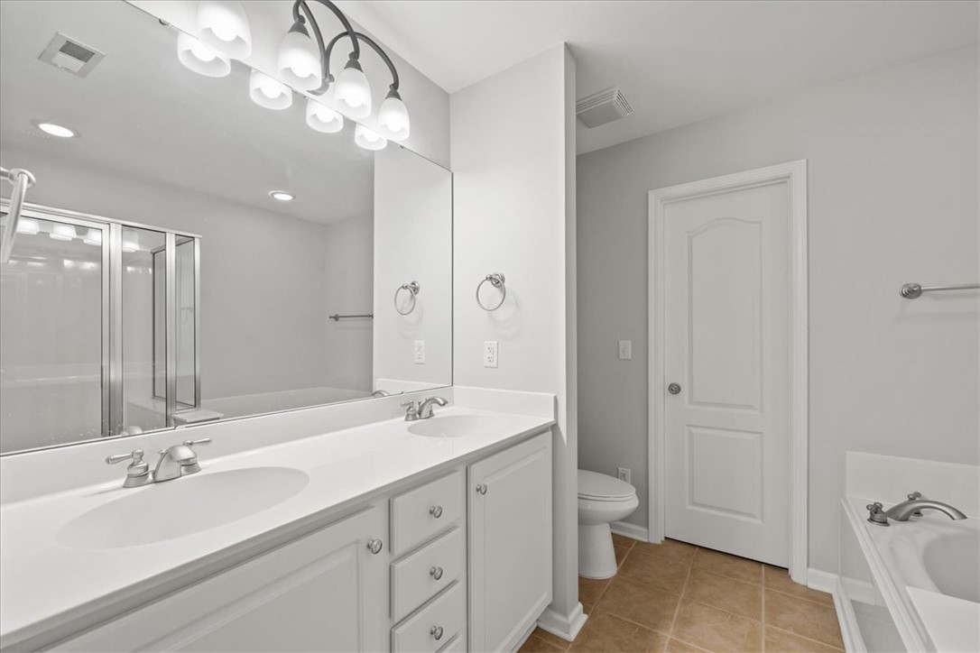 100 Shipyard Circle Anderson, SC 29621 - Photo 22 of 40 This spacious bathroom offers a double vanity and a glass-enclosed shower for daily convenience.