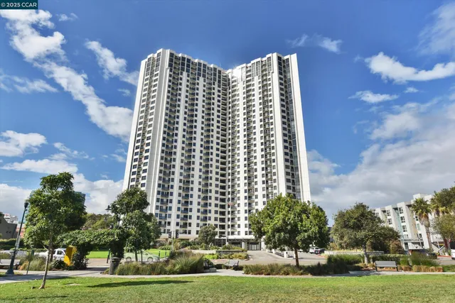 a large building with trees in the background