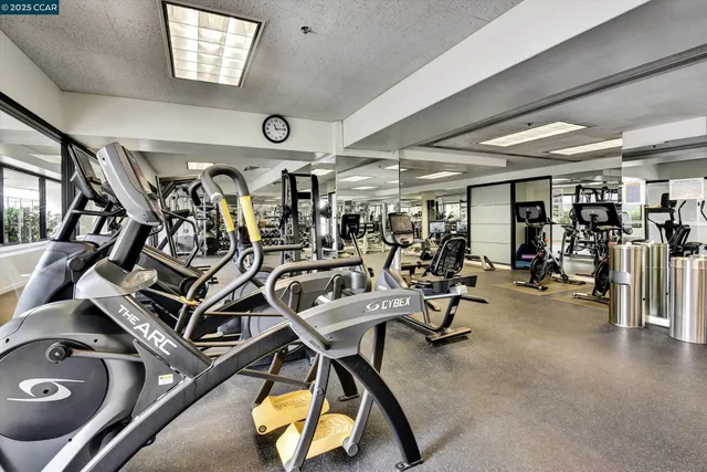 a living room with furniture kitchen view and a large window
