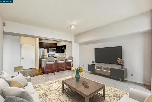 a kitchen with stainless steel appliances granite countertop a refrigerator a sink a stove and a microwave