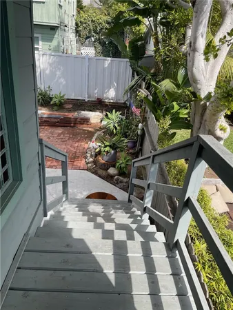 a view of a hallway with wooden floor and a window
