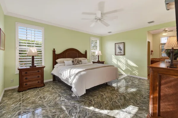 a bedroom with a bed and a flat tv screen on dresser