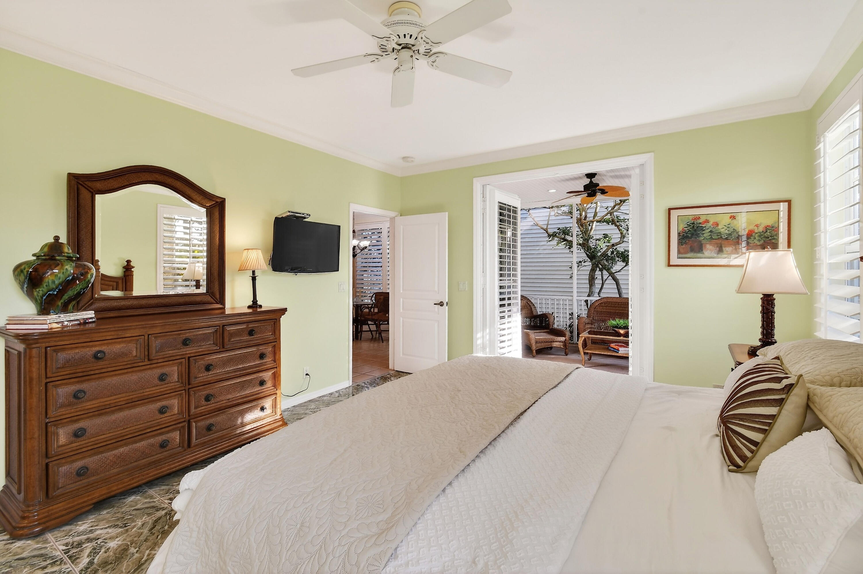 154 Jupiter Key Road Jupiter, FL 33477 - Photo 16 of 64 a bedroom with a bed and a flat tv screen on dresser