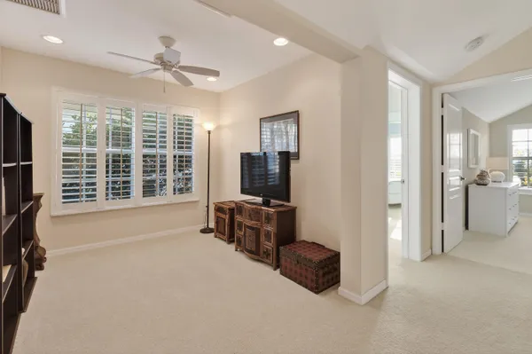a bedroom with a bed and ceiling fan