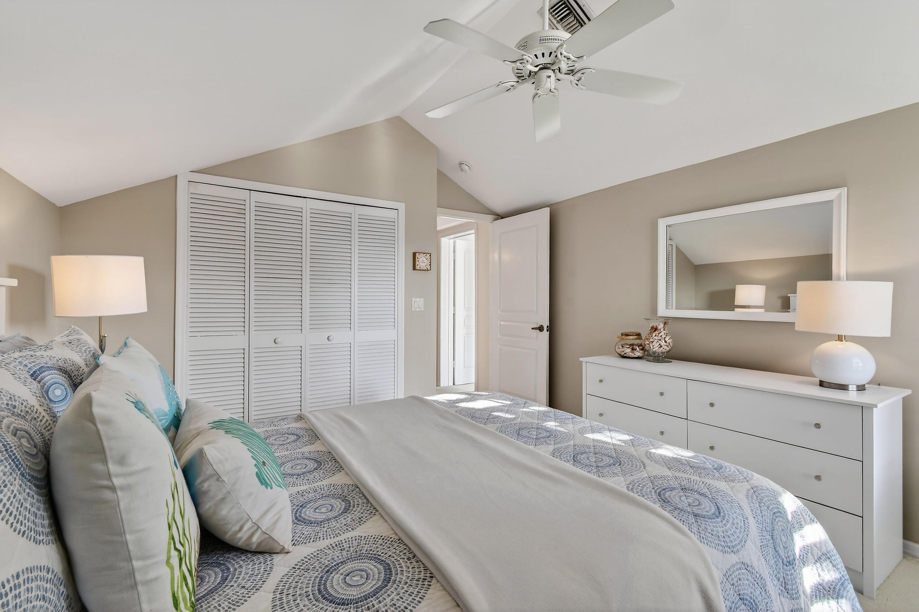 154 Jupiter Key Road Jupiter, FL 33477 - Photo 26 of 64 a bedroom with a bed and ceiling fan