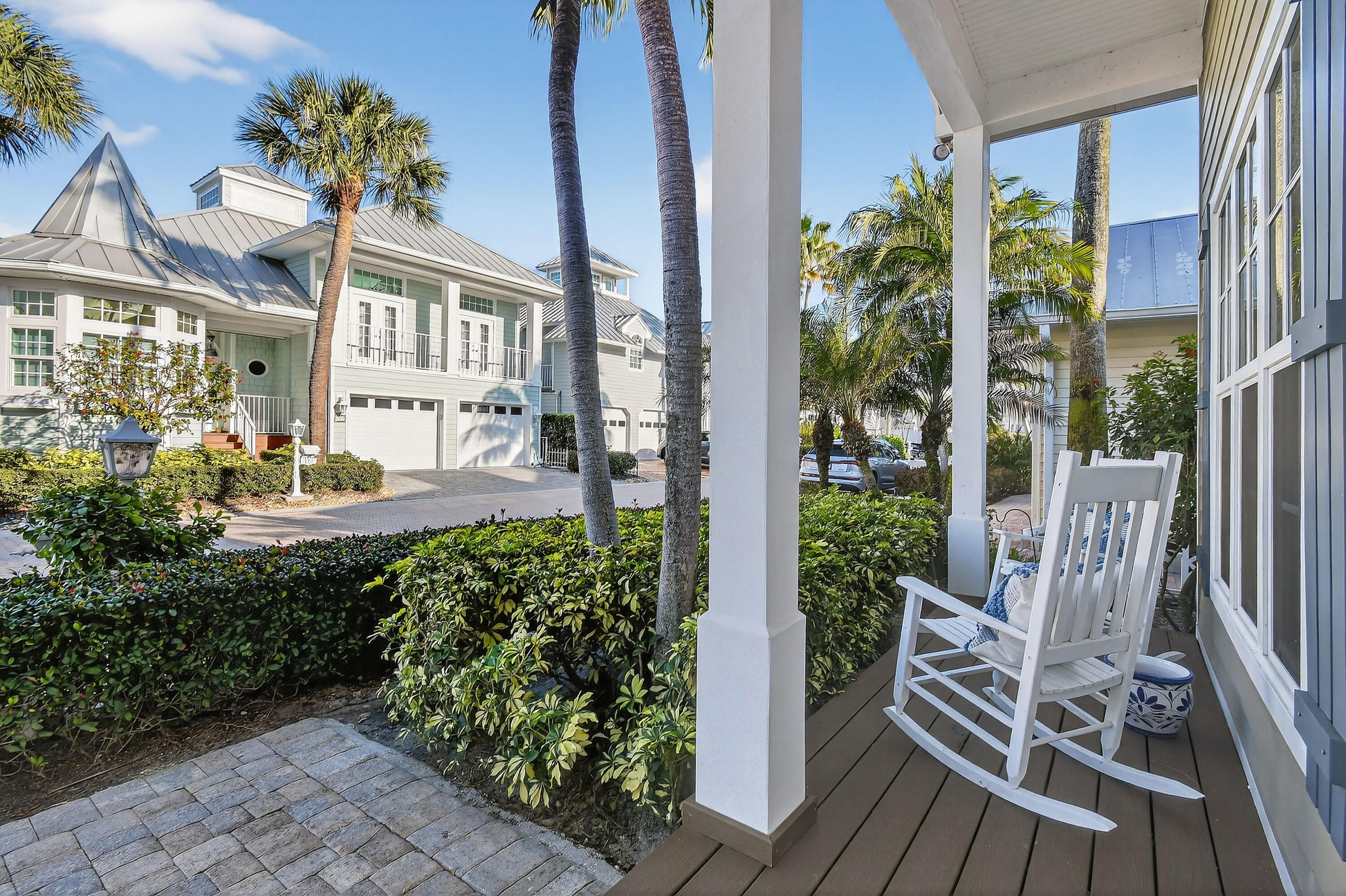154 Jupiter Key Road Jupiter, FL 33477 - Photo 4 of 64 a view of an entryway with a flower garden and wooden floor
