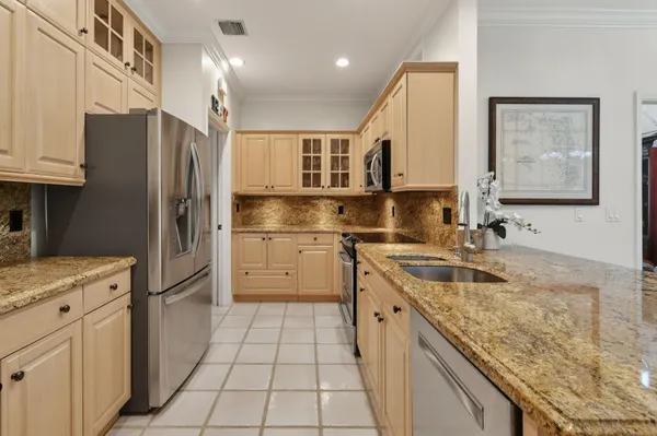 a living room with furniture a rug and a chandelier
