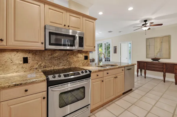 a kitchen with cabinets and chairs