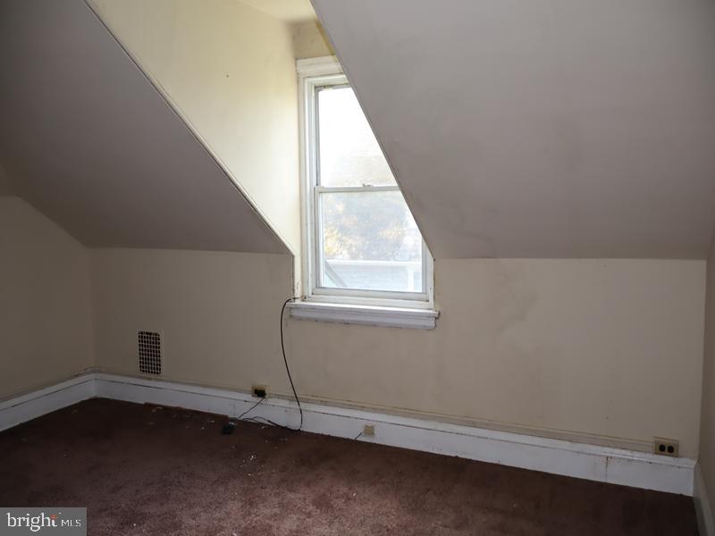 6386 Sherwood Road Philadelphia, PA 19151 - Photo 14 of 18 an empty room with wooden floor and windows
