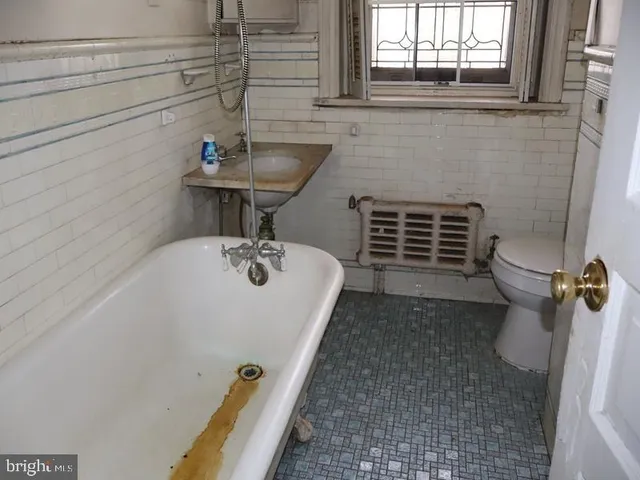 a bathroom with a sink a toilet and window