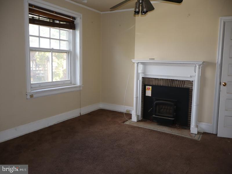 6386 Sherwood Road Philadelphia, PA 19151 - Photo 6 of 18 an empty room with windows and fireplace