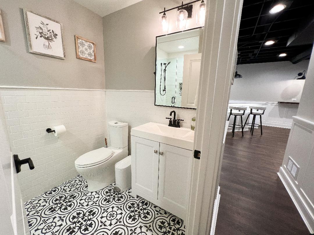 3503 Deep Cut Road Woodstock, IL 60098 - Photo 30 of 34 a bathroom with a toilet a sink and a mirror