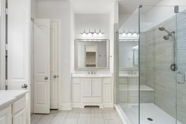 a bathroom with a tub shower and sink