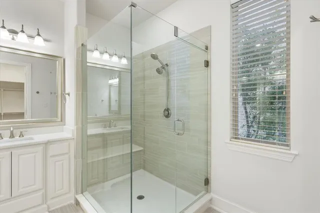 a bathroom with a shower sink and mirror