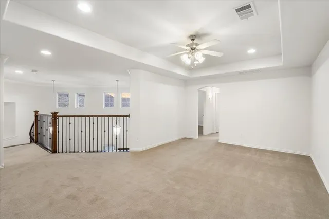 a view of a livingroom with a ceiling fan and window