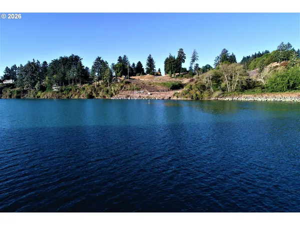 a view of a lake next to a mountain