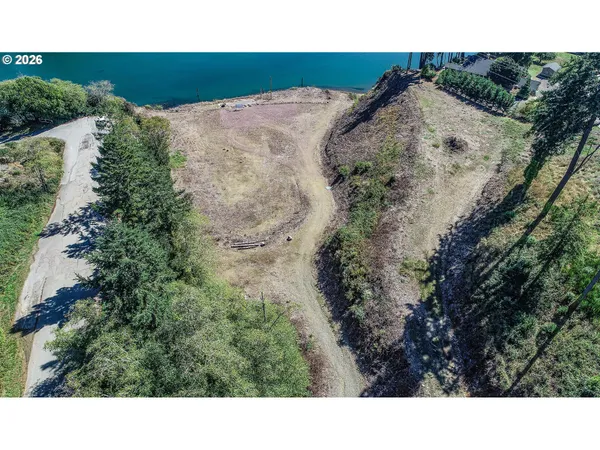 a view of a yard with wooden fence
