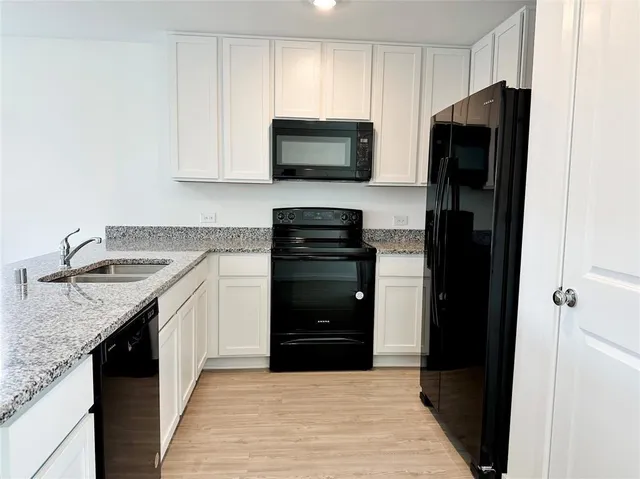 a kitchen with a sink stove and refrigerator