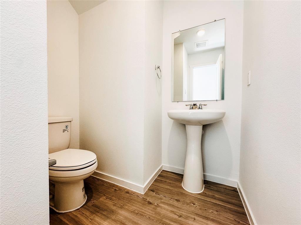 6206 Sanderling Street Princeton, TX 75407 - Photo 5 of 15 a bathroom with a sink and a toilet