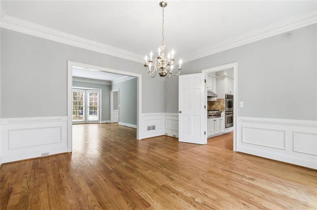 3463 Buck Hill Road Marietta, GA 30067 - Photo 19 of 82 a view of an empty room with wooden floor and cabinet