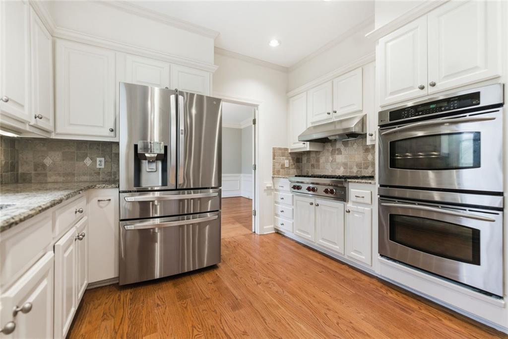 3463 Buck Hill Road Marietta, GA 30067 - Photo 23 of 82 a kitchen with stainless steel appliances and white cabinets