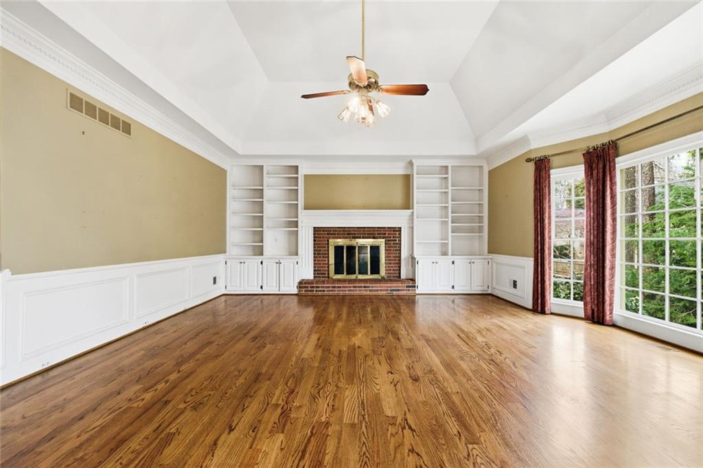3463 Buck Hill Road Marietta, GA 30067 - Photo 33 of 82 an empty room with wooden floor fireplace and windows