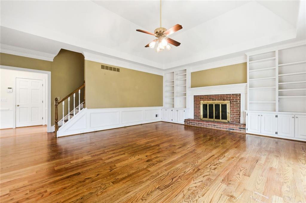 3463 Buck Hill Road Marietta, GA 30067 - Photo 34 of 82 a view of an empty room with wooden floor and a fireplace