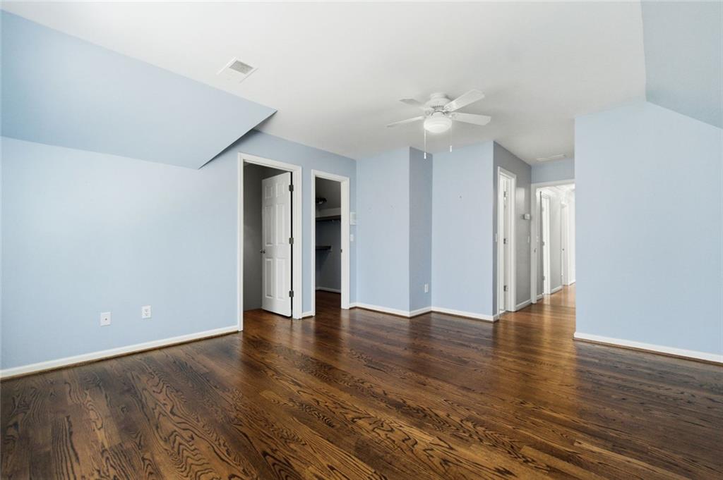 3463 Buck Hill Road Marietta, GA 30067 - Photo 62 of 82 a view of an empty room with wooden floor and a ceiling fan