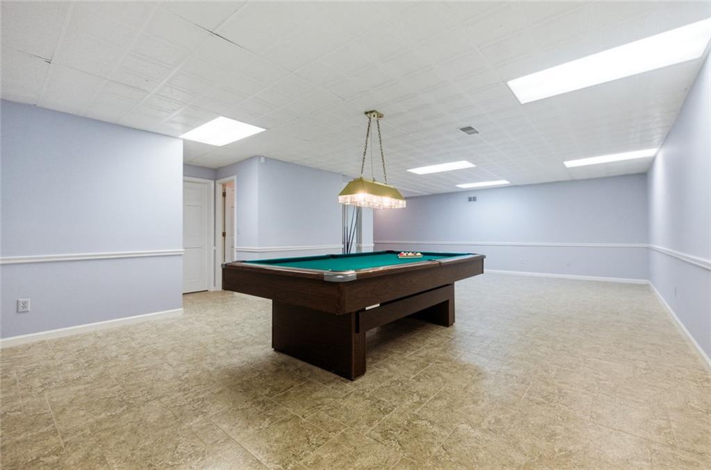3463 Buck Hill Road Marietta, GA 30067 - Photo 66 of 82 a room with pool table and a chandelier