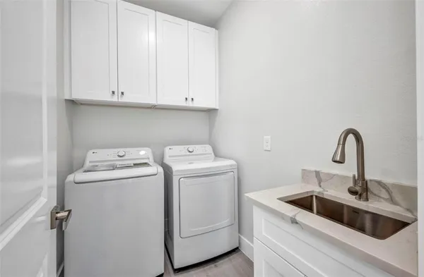 a view of storage and utility room with a washer dryer