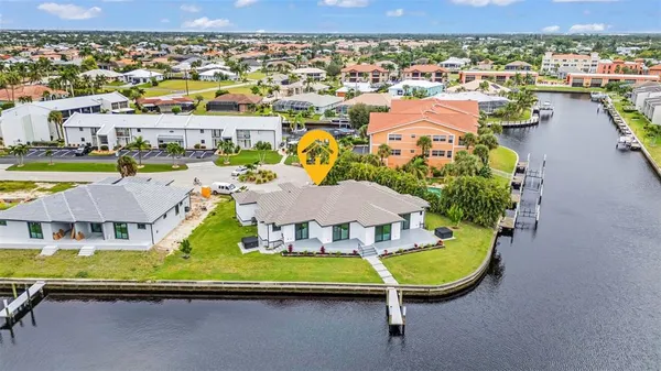 an aerial view of a house with yard swimming pool and ocean view