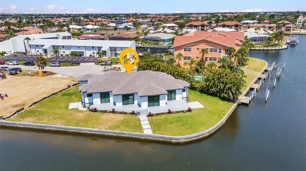 an aerial view of residential houses with outdoor space and river