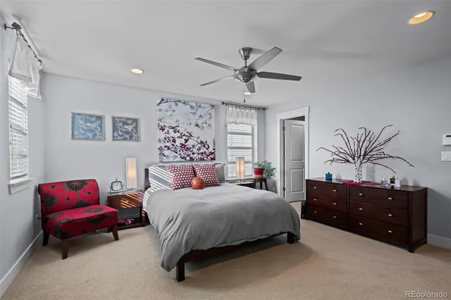 a spacious bedroom with a bed dresser and a window