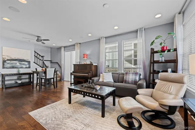a living room with furniture a rug and a flat screen tv
