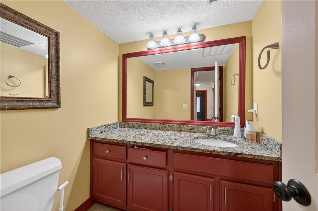 2878 Cardinal Trace Duluth, GA 30096 - Photo 15 of 42 a bathroom with a granite countertop sink and a mirror