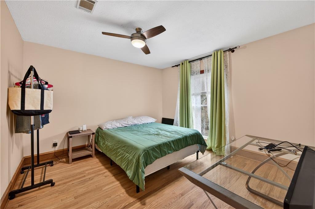 2878 Cardinal Trace Duluth, GA 30096 - Photo 17 of 42 a bedroom with a bed and a chandelier