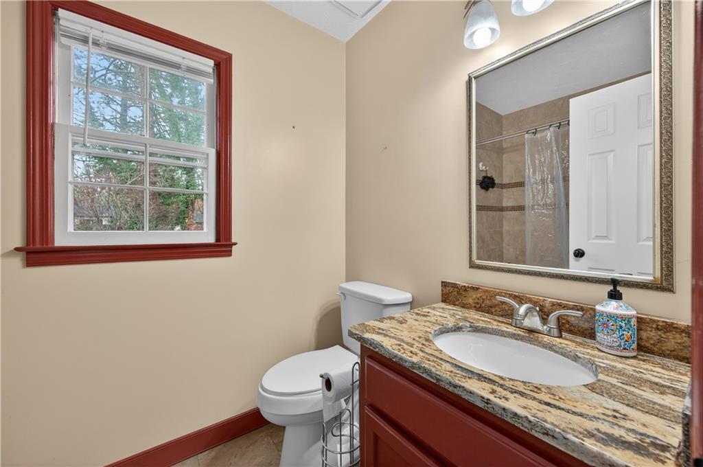 2878 Cardinal Trace Duluth, GA 30096 - Photo 20 of 42 a bathroom with a granite countertop toilet a sink and a mirror