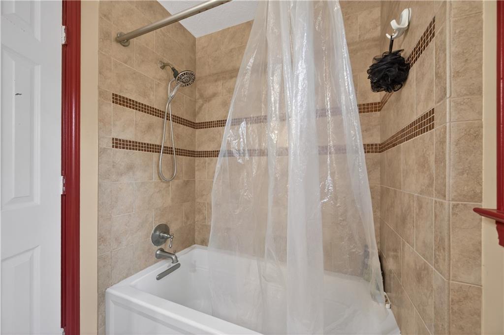 2878 Cardinal Trace Duluth, GA 30096 - Photo 21 of 42 a bathroom with a tub and shower