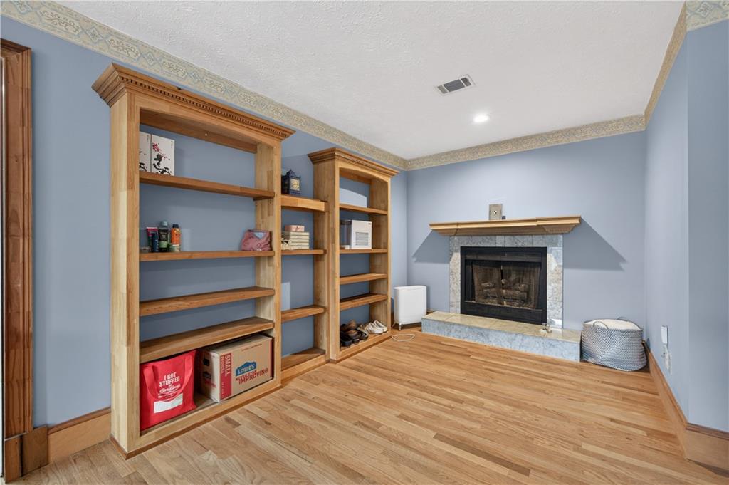 2878 Cardinal Trace Duluth, GA 30096 - Photo 23 of 42 a living room with furniture a fireplace and a wooden floor