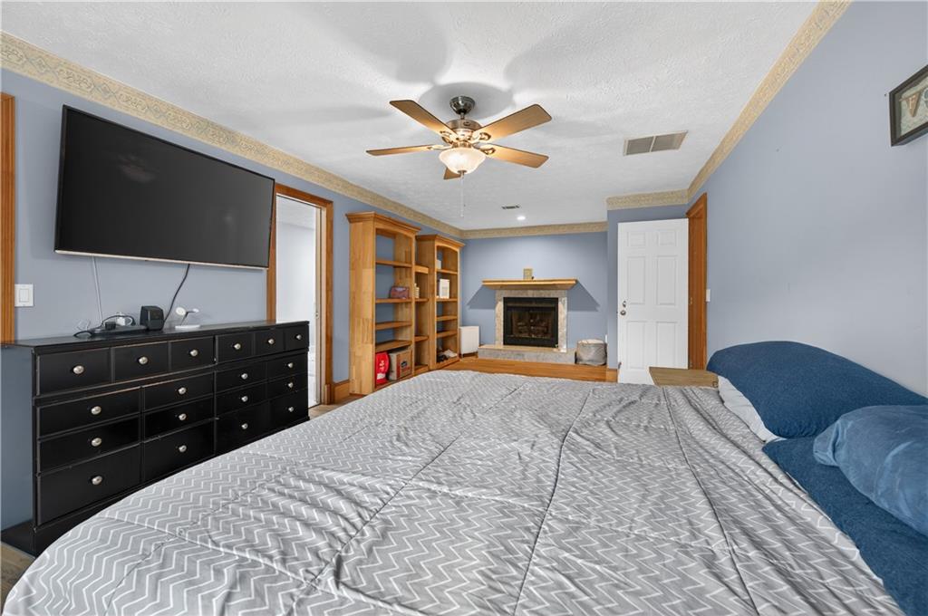 2878 Cardinal Trace Duluth, GA 30096 - Photo 24 of 42 a bedroom with a bed and a flat screen tv