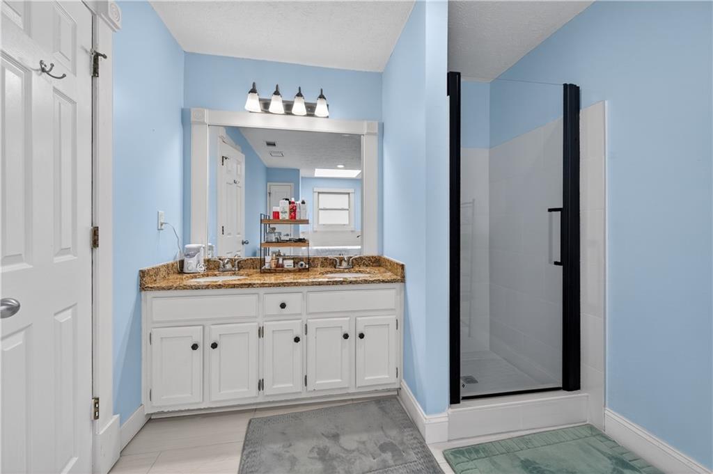 2878 Cardinal Trace Duluth, GA 30096 - Photo 25 of 42 a bathroom with a sink vanity and mirror