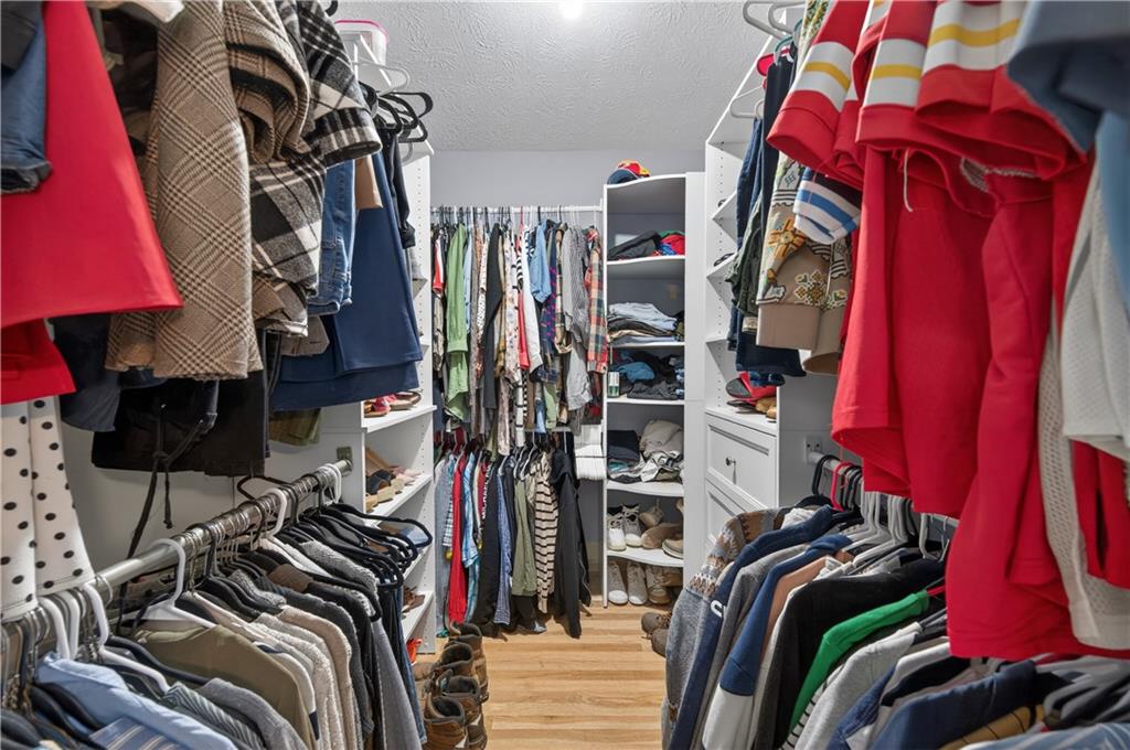 2878 Cardinal Trace Duluth, GA 30096 - Photo 27 of 42 a view of walk in closet with clothes and shoes