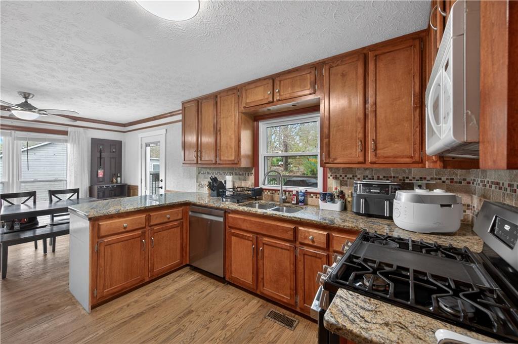 2878 Cardinal Trace Duluth, GA 30096 - Photo 6 of 42 a kitchen with a sink a stove and cabinets