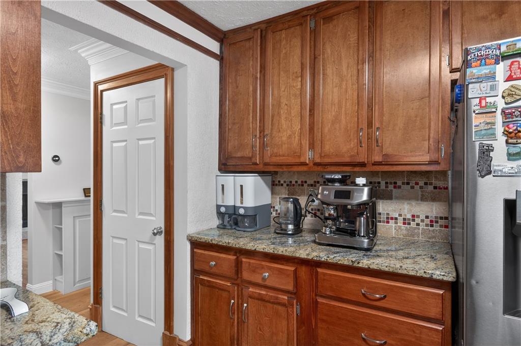 2878 Cardinal Trace Duluth, GA 30096 - Photo 9 of 42 a kitchen with granite countertop wooden cabinets and a sink